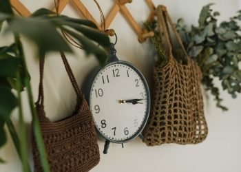 analogue_clock_hanging_between_crocheted_bags analogue_clock_hanging_between_crocheted_bags