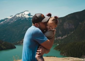 father_kissing_small_daughter_while_hugging father_kissing_small_daughter_while_hugging
