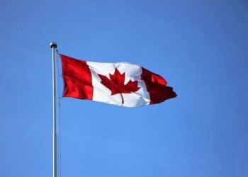 flag_of_canada_against_a_blue_sky flag_of_canada_against_a_blue_sky