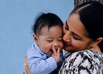 mother_kissing_infant_while_hugging mother_kissing_infant_while_hugging