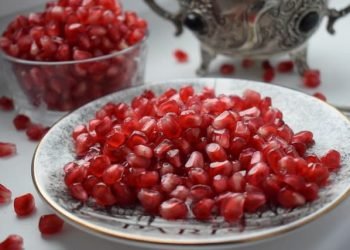 red_round_seeds_of_pomegranate_in_a_white_glass_bowl red_round_seeds_of_pomegranate_in_a_white_glass_bowl